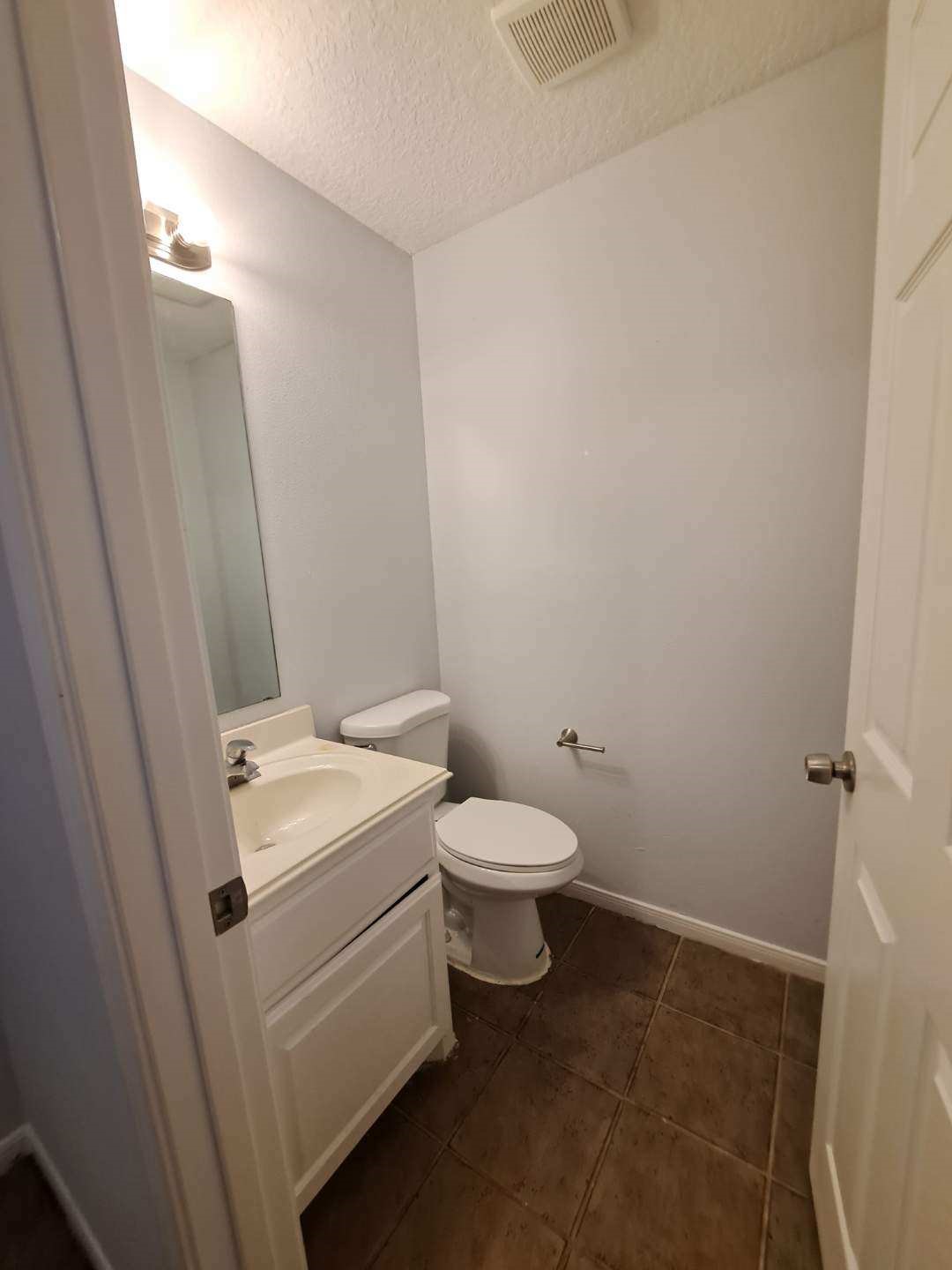 7411 Augusta Lane Rosharon, TX 77583 - Photo 37 of 38 a white toilet sitting next to a white sink and vanity
