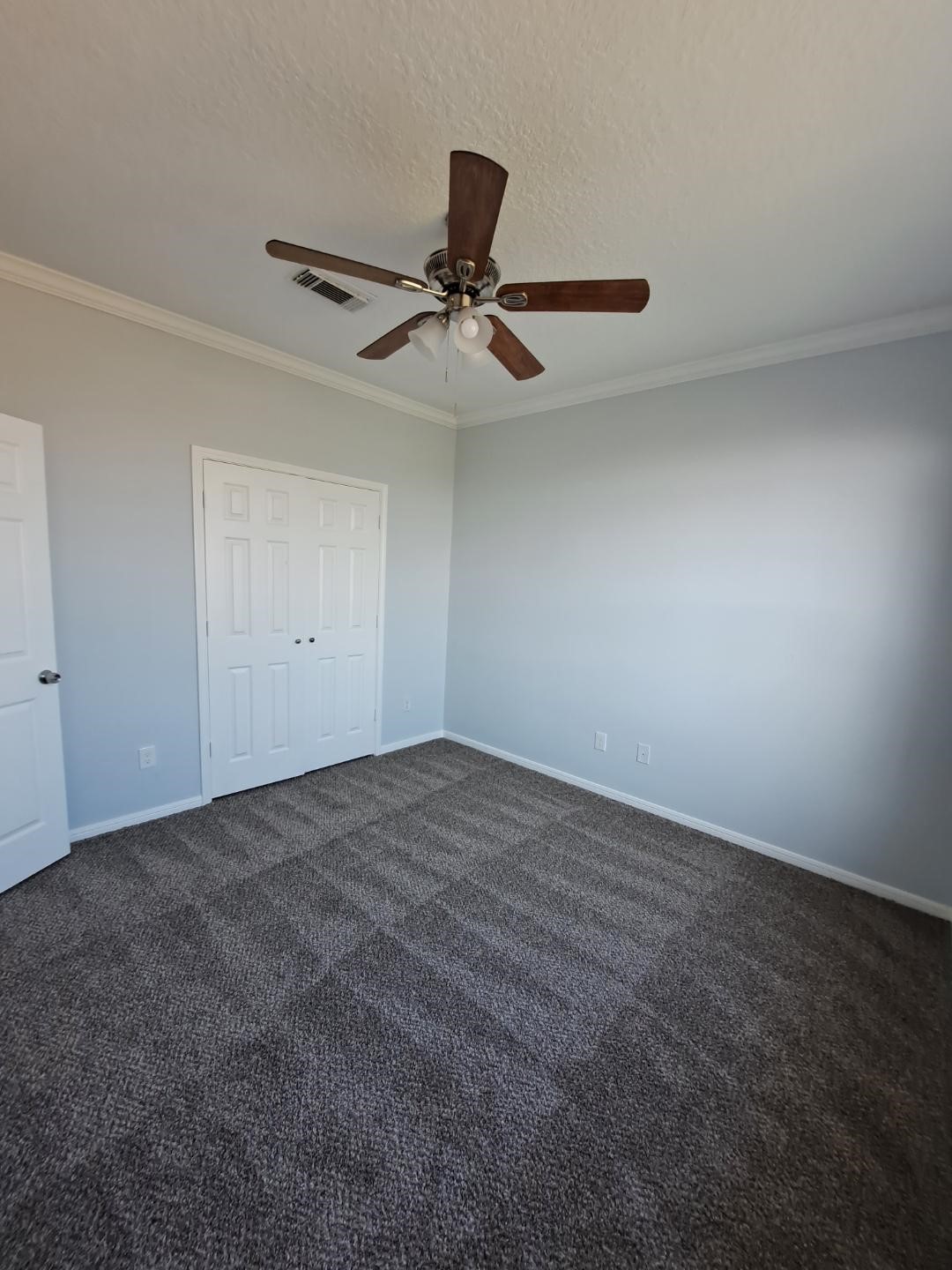 7411 Augusta Lane Rosharon, TX 77583 - Photo 5 of 38 an empty room with a ceiling fan and window