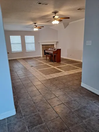 a view of a livingroom with furniture and chandelier fan