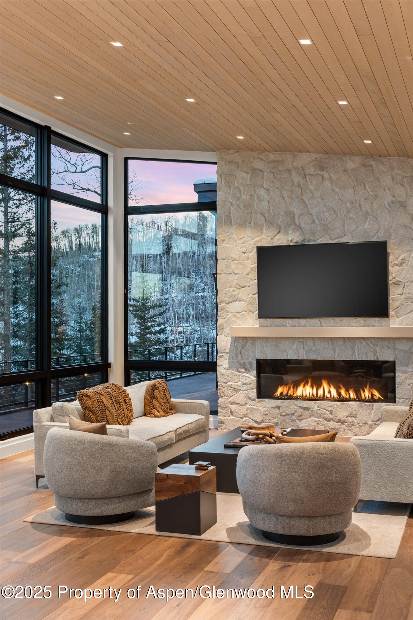 1234 Wood Road Snowmass Village, CO 81615 - Photo 63 of 66 a living room with furniture and a flat screen tv