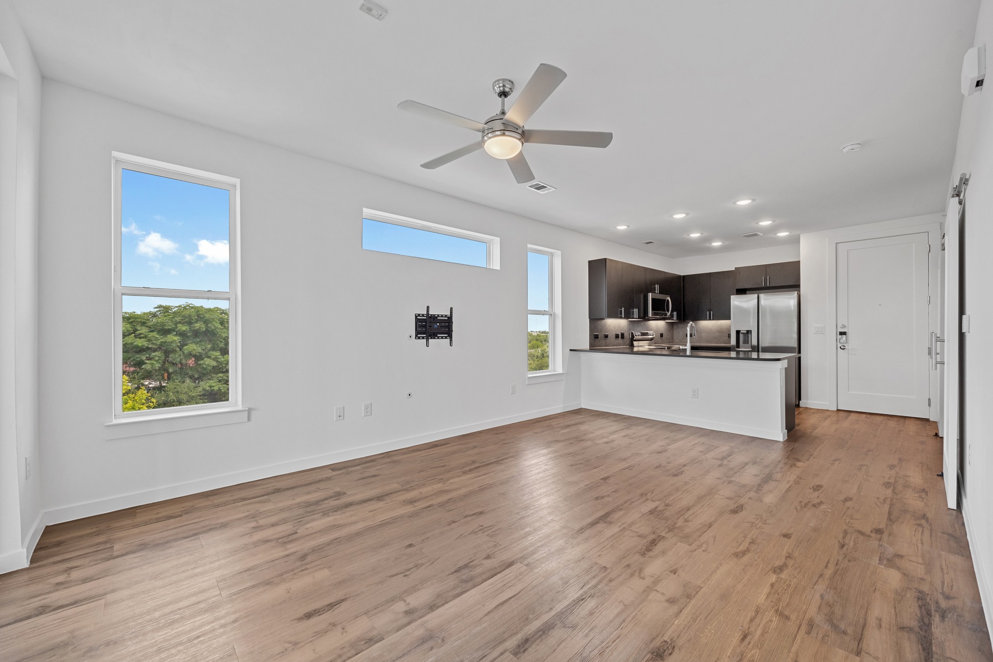 4801 Springdale Road, Unit 2301 Austin, TX 78723 - Photo 36 of 36 An open floorplan with durable laminate flooring seamlessly connects the living space to a contemporary kitchen.