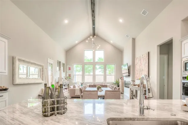 a spacious bedroom with a bed and a chandelier
