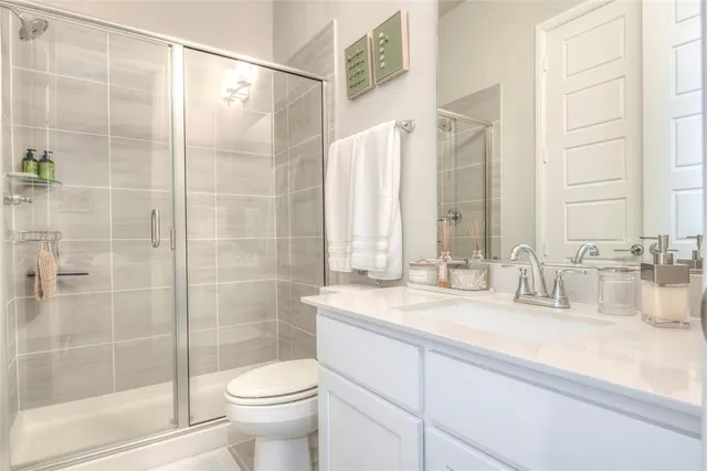 a bedroom with a bed and a chair in it