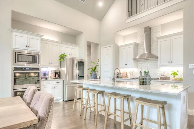 a large kitchen with a counter space and stainless steel appliances