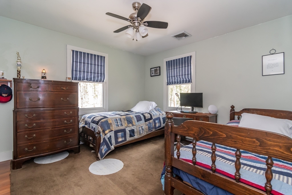 8 Meeting House Hill Road Dover, MA 02030 - Photo 15 of 22 a bedroom with a bed and a chandelier