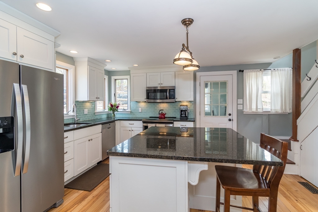 8 Meeting House Hill Road Dover, MA 02030 - Photo 5 of 22 a kitchen with stainless steel appliances granite countertop a sink refrigerator and microwave