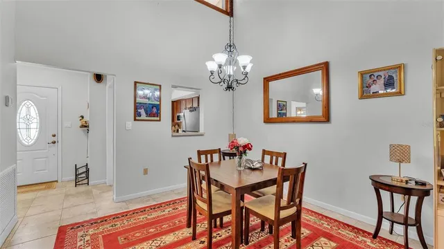 a view of a dining room with furniture and chandelier