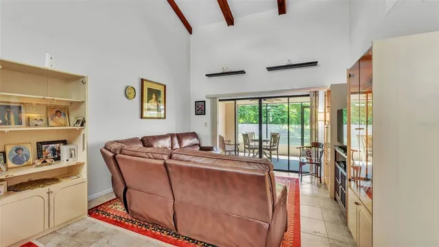 a living room with furniture and a floor to ceiling window