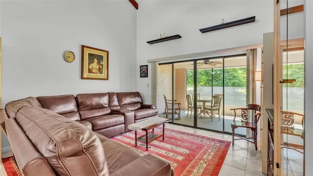 a living room with furniture and a floor to ceiling window