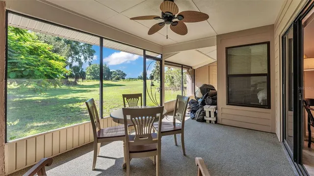 a view of a porch with furniture and a yard