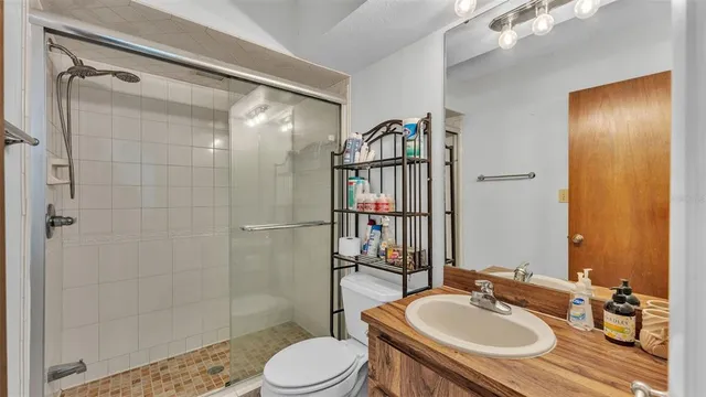 a bathroom with a sink toilet and shower