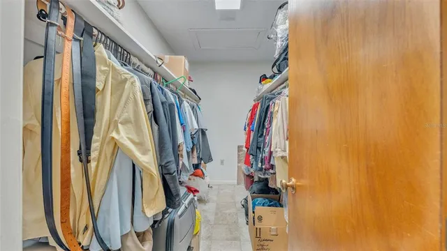 a view of walk in closet with clothes