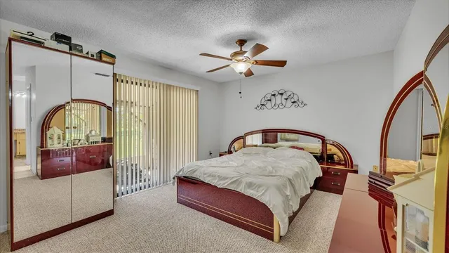 a bedroom with a bed dresser and a window