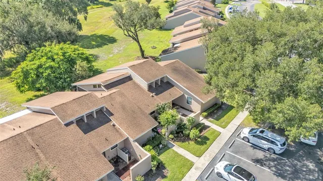 an aerial view of a house with garden space and street view