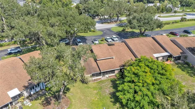 an aerial view of a house with a yard basket ball court and outdoor seating
