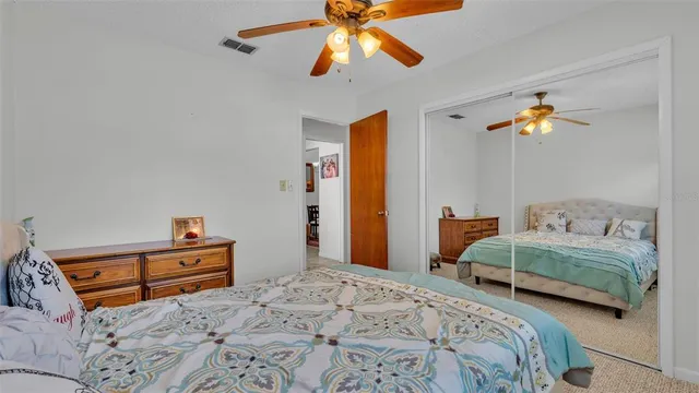 a bedroom with two beds and a chandelier