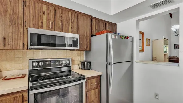 a kitchen with appliances and cabinets