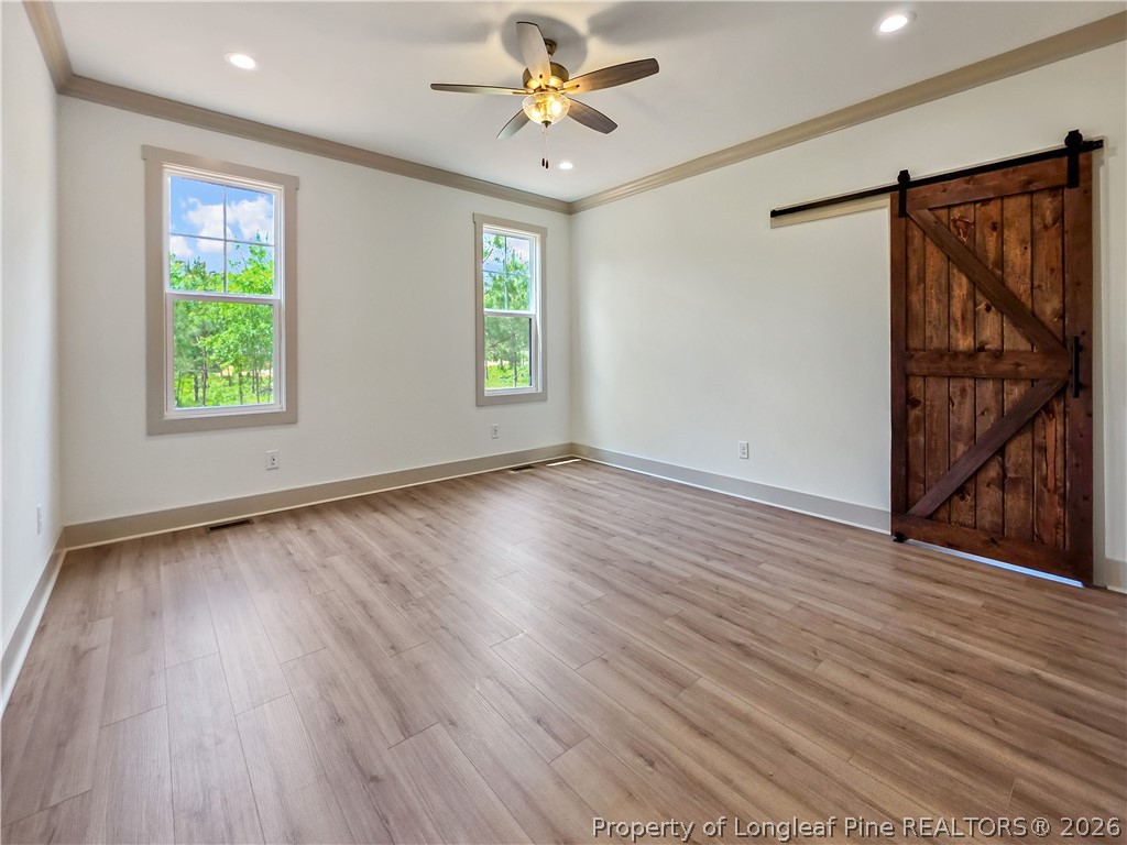 900 Niagara Carthage Road Carthage, NC 28327 - Photo 10 of 38 wooden floor in an empty room with a window