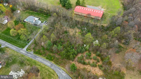 an aerial view of a houses with outdoor space and lake view