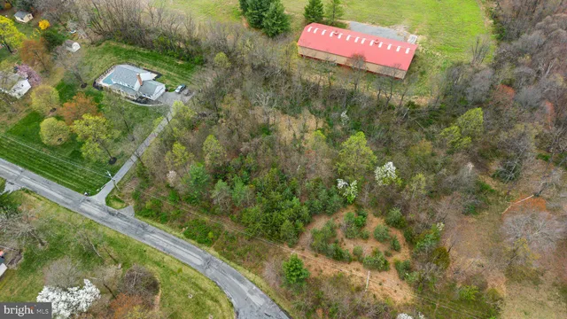 an aerial view of a houses with outdoor space and lake view