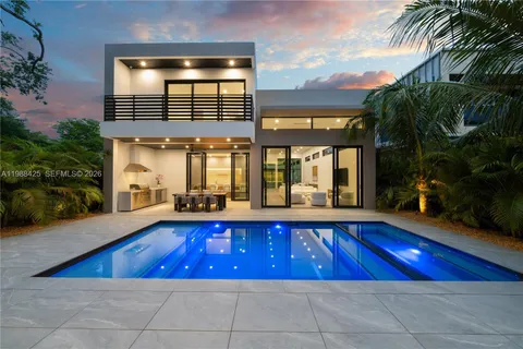 a view of a house with backyard sitting area and porch