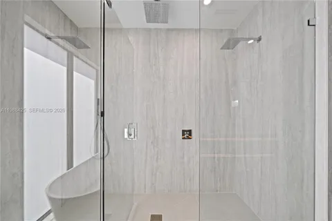 a view of a patio with a table and chairs under an umbrella