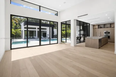 a view of an entryway with a floor to ceiling window and a living room view