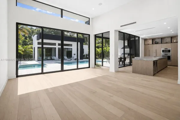 a view of an entryway with a floor to ceiling window and a living room view