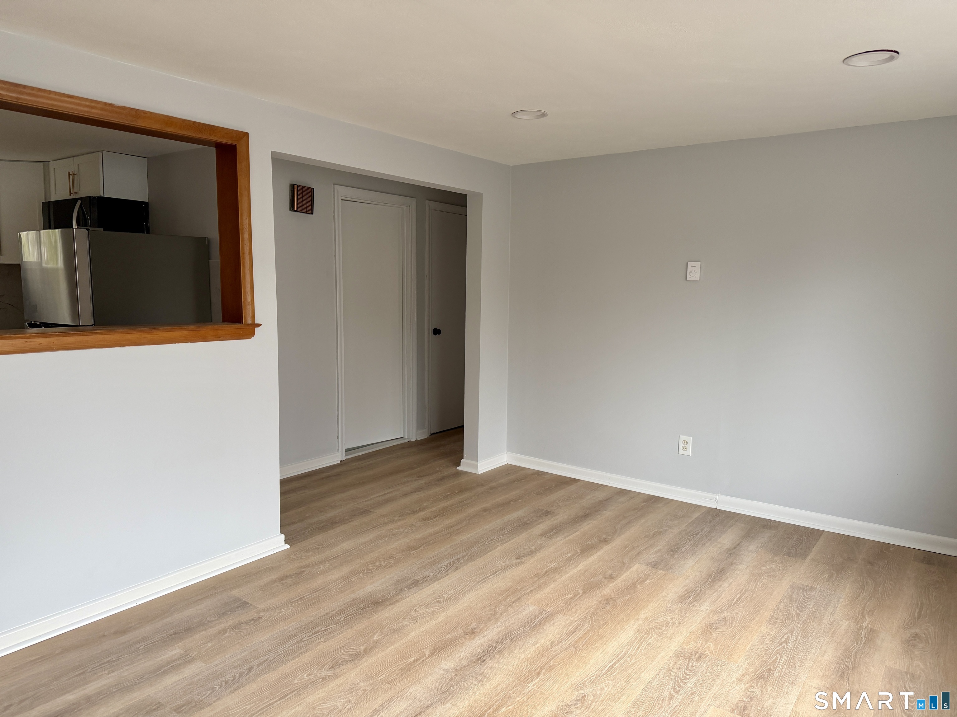 164 Sycamore Street, Unit 1R Bristol, CT 06010 - Photo 5 of 10 a view of an empty room with wooden floor and closet