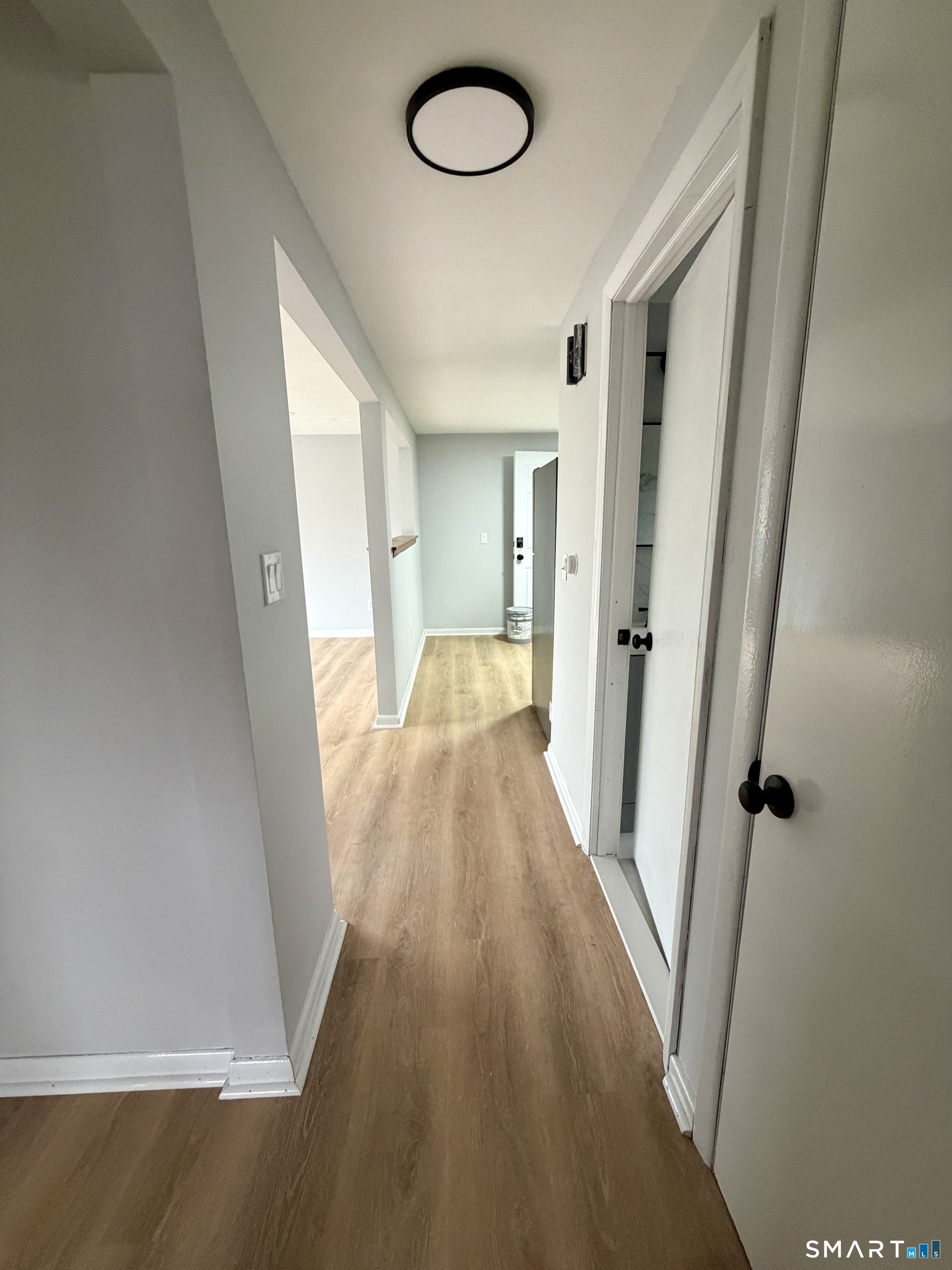 164 Sycamore Street, Unit 1R Bristol, CT 06010 - Photo 8 of 10 a view of a room with wooden floor and staircase