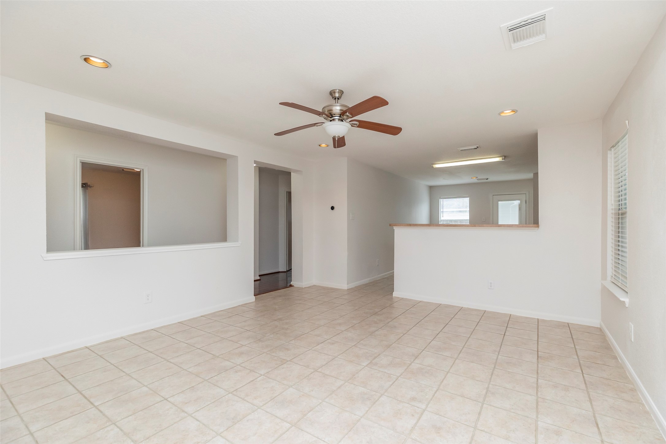 21202 Fire Wind Court Spring, TX 77379 - Photo 3 of 21 Bright Living Room. Spacious living area featuring large windows that fill the space with natural light.