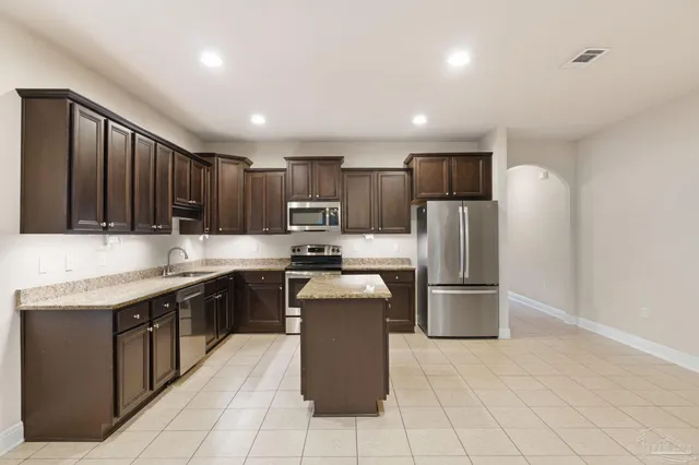 a kitchen with refrigerator and cabinets