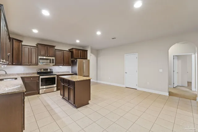 a kitchen with a stove a sink and a refrigerator