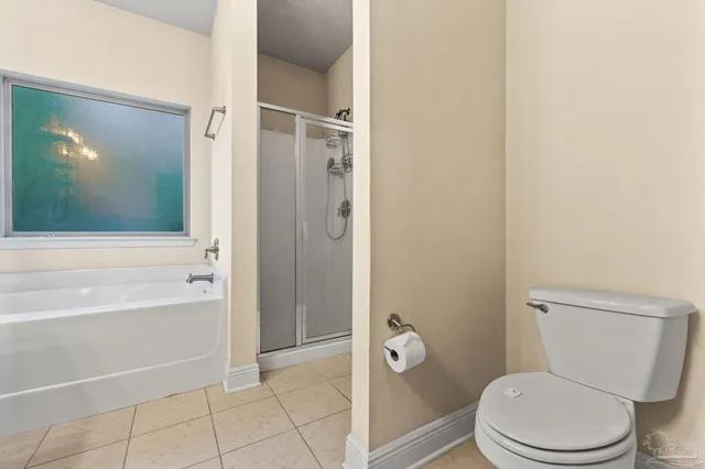 a white toilet sitting next to a bathroom sink and tub