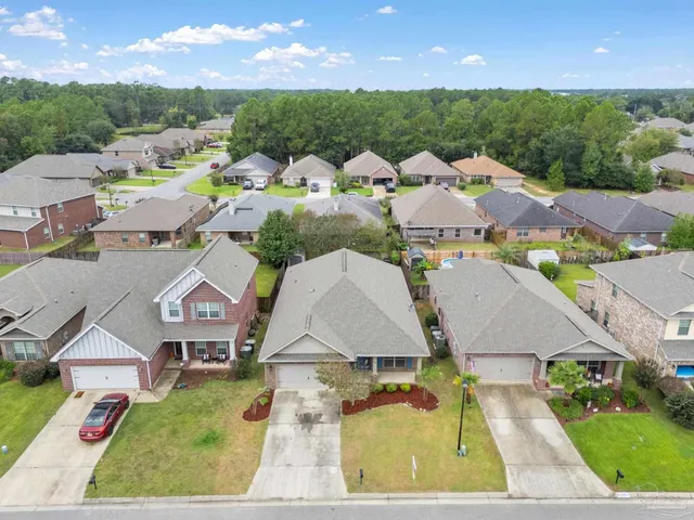 an aerial view of residential houses with outdoor space and street view