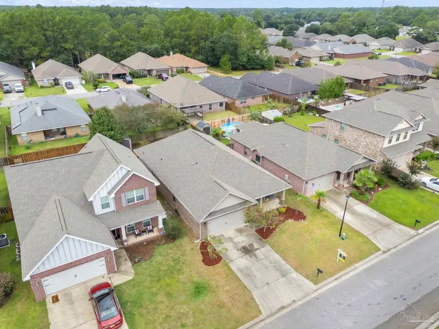 an aerial view of residential houses with outdoor space