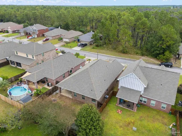 an aerial view of a house with swimming pool outdoor seating and yard
