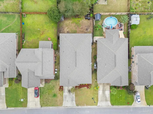 an aerial view of a house with a yard basket ball court and outdoor seating