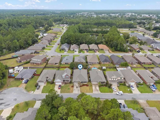 an aerial view of residential houses with outdoor space