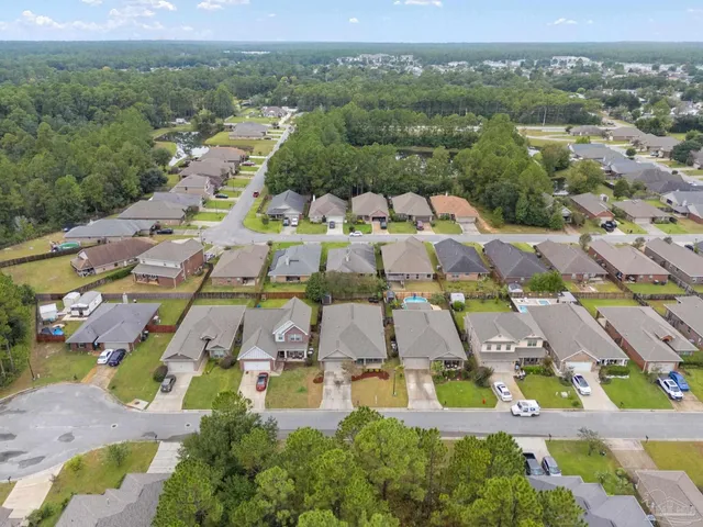 an aerial view of residential houses with outdoor space