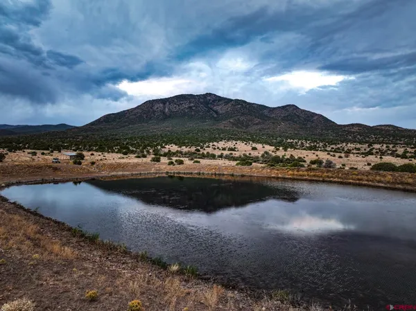 a view of a lake with a house in the background