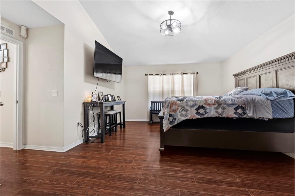 2881 Southwest 142nd Lane Ocala, FL 34473 - Photo 13 of 60 a bed room with furniture and a flat screen tv