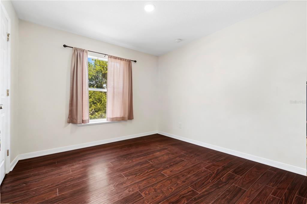2881 Southwest 142nd Lane Ocala, FL 34473 - Photo 19 of 60 an empty room with wooden floor and windows