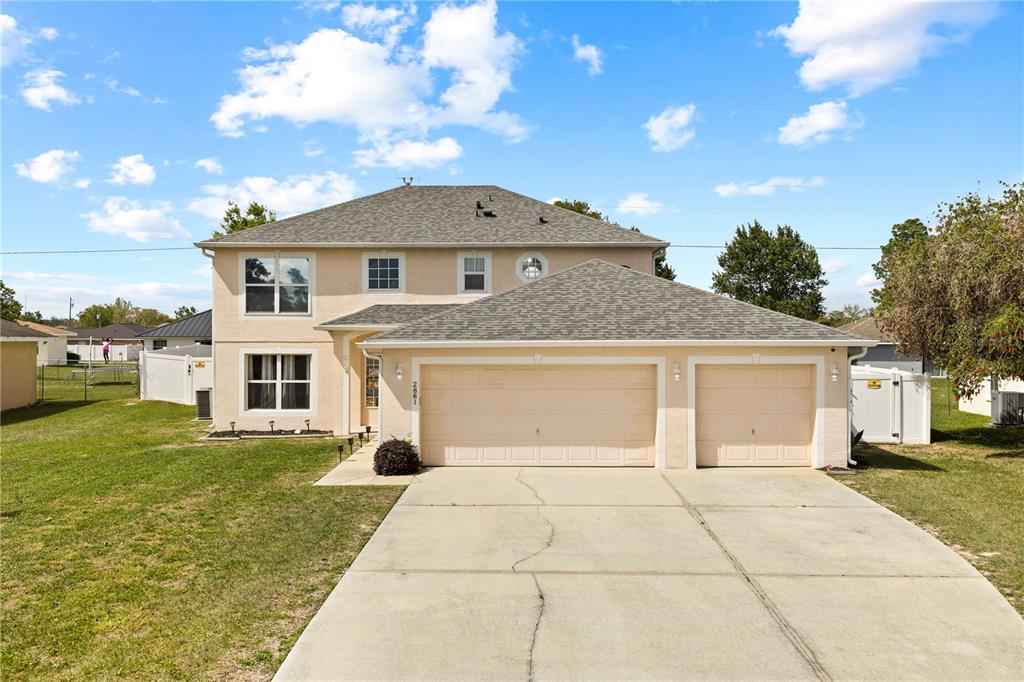 2881 Southwest 142nd Lane Ocala, FL 34473 - Photo 2 of 60 a front view of a house with garden
