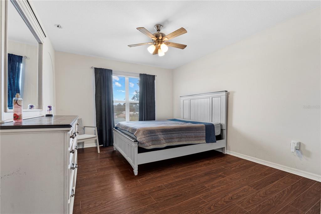 2881 Southwest 142nd Lane Ocala, FL 34473 - Photo 22 of 60 a bedroom with a bed and a table