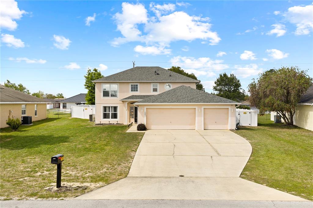 2881 Southwest 142nd Lane Ocala, FL 34473 - Photo 23 of 60 a front view of a house with garden
