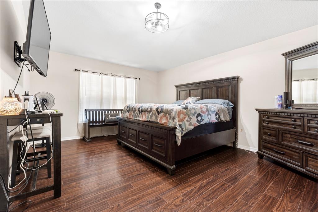 2881 Southwest 142nd Lane Ocala, FL 34473 - Photo 26 of 60 a bedroom with a bed and wooden floor