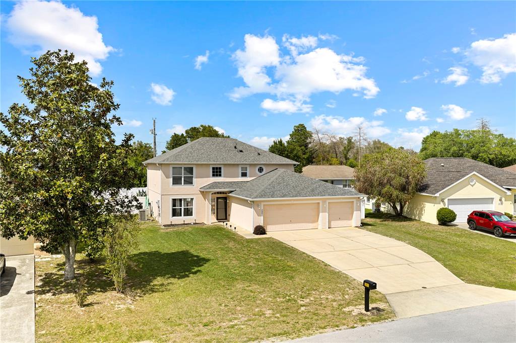 2881 Southwest 142nd Lane Ocala, FL 34473 - Photo 30 of 60 a front view of a house with a yard
