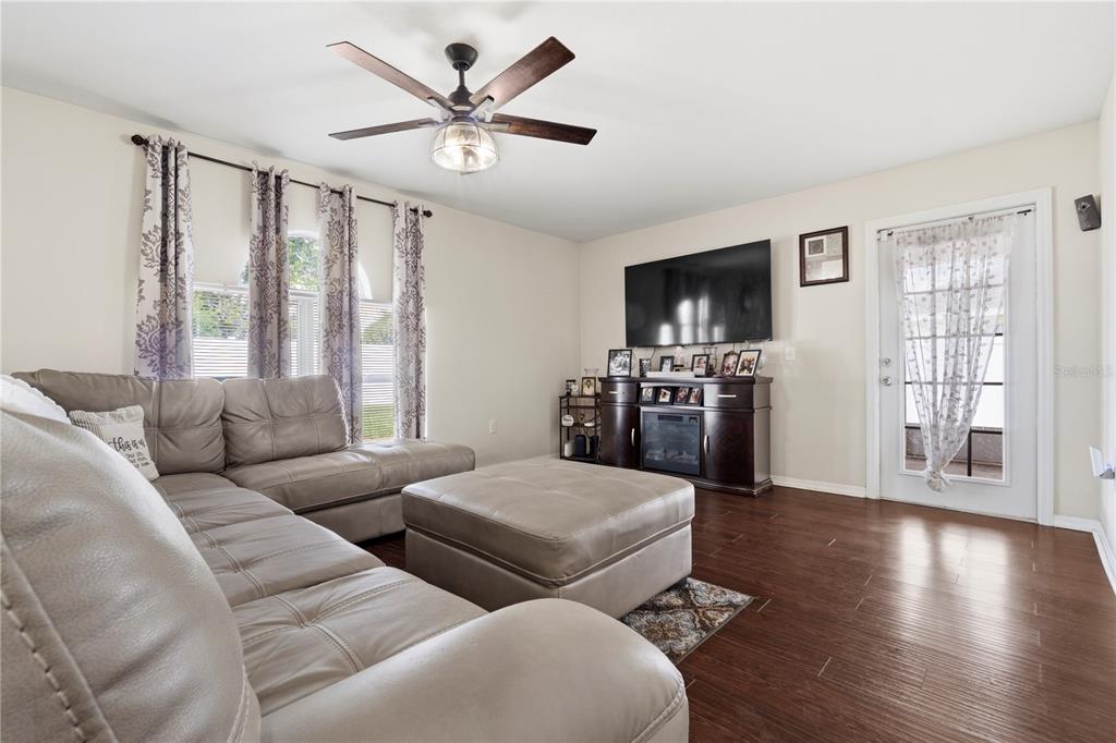 2881 Southwest 142nd Lane Ocala, FL 34473 - Photo 38 of 60 a living room with furniture flat screen tv and wooden floor
