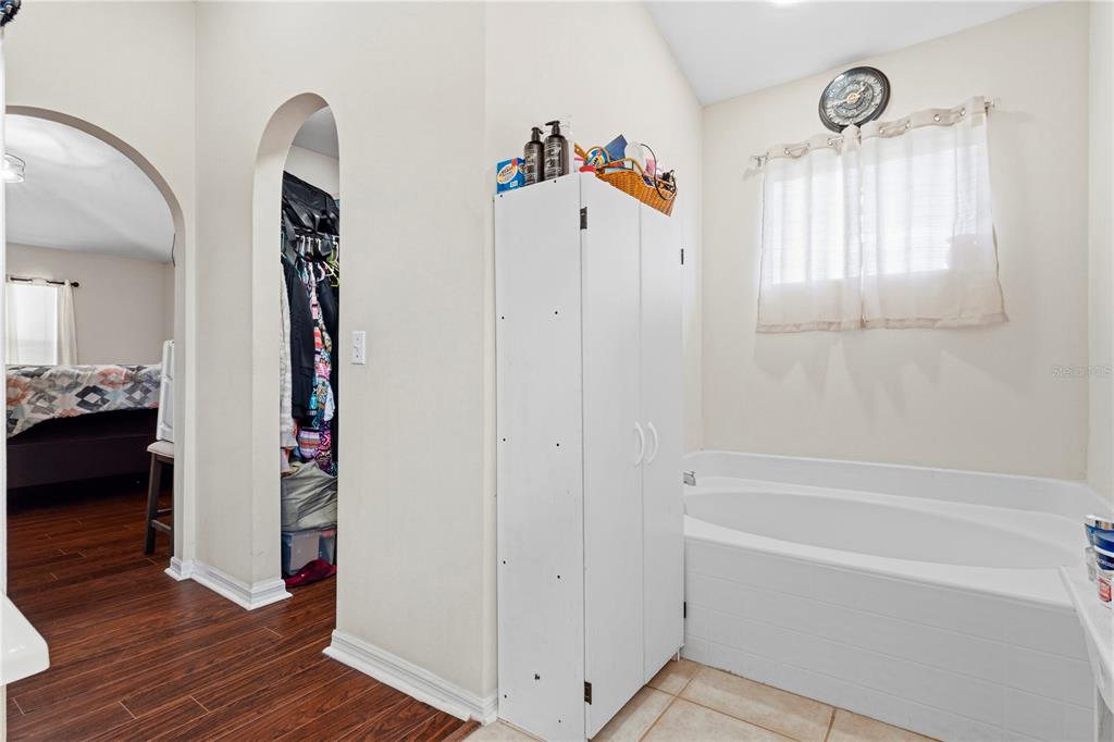 2881 Southwest 142nd Lane Ocala, FL 34473 - Photo 4 of 60 a view of a bedroom with wooden floor & a window